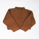 A brown knit  sweater laid flat 