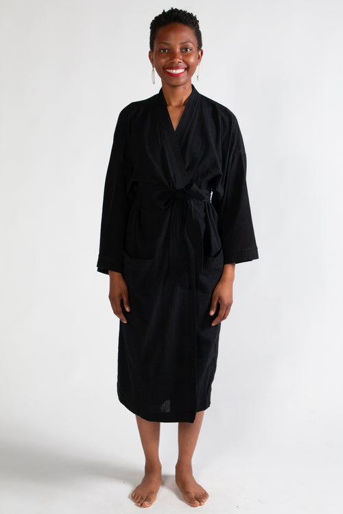 Woman wearing a black robe on a white background