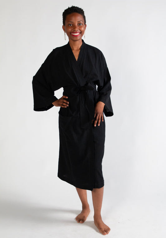 Woman wearing a black robe on a white background