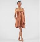 Woman wearing a brown dress on a white background