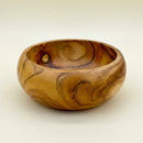 A handcrafted wooden bowl with a rich golden-brown and amber wood grain pattern