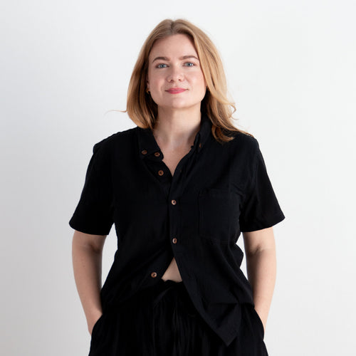Woman wearing a black outfit against a white background