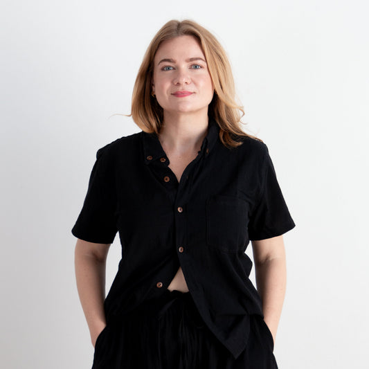Woman wearing a black outfit against a white background