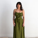 Woman wearing a green dress against a white background