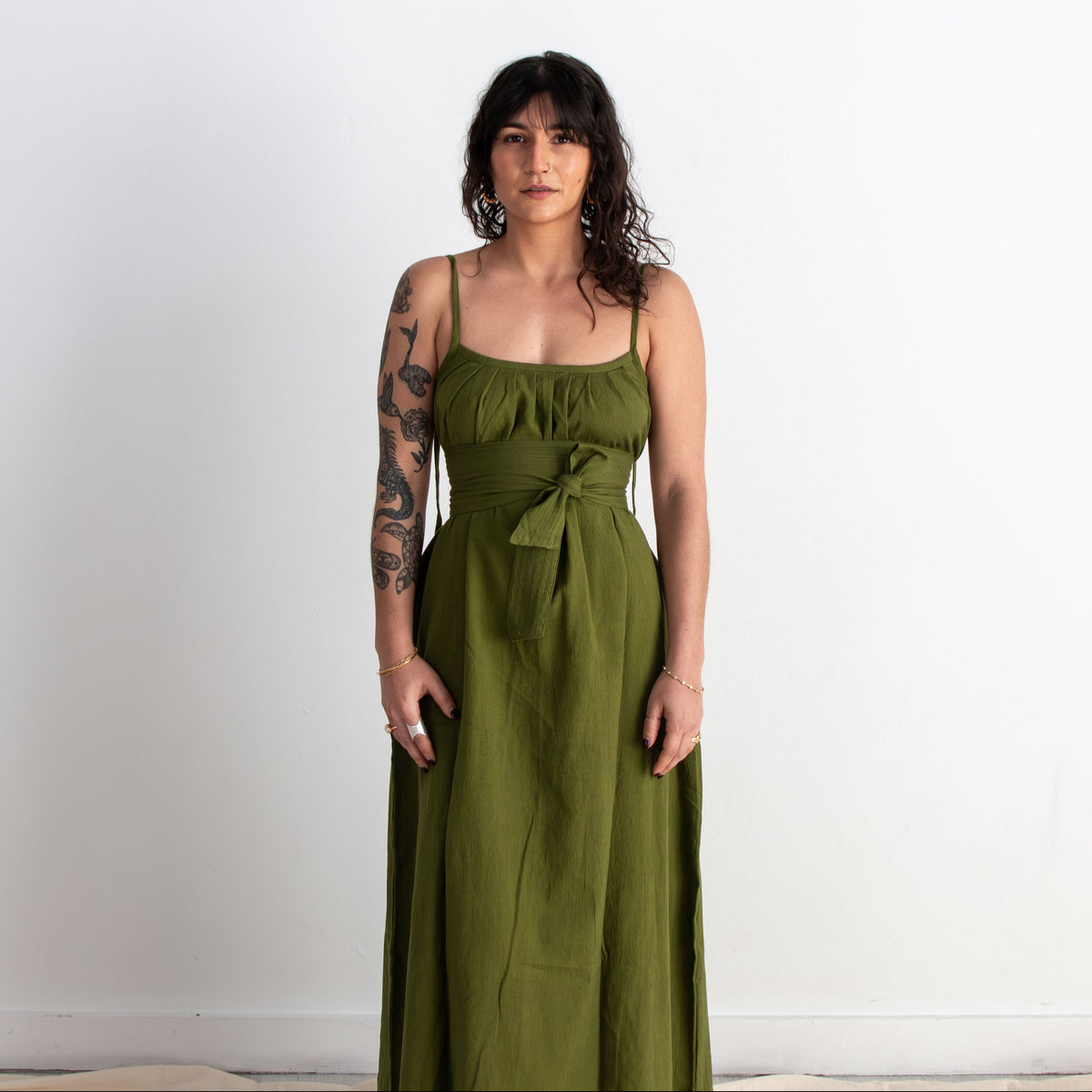 Woman wearing a green dress against a white background