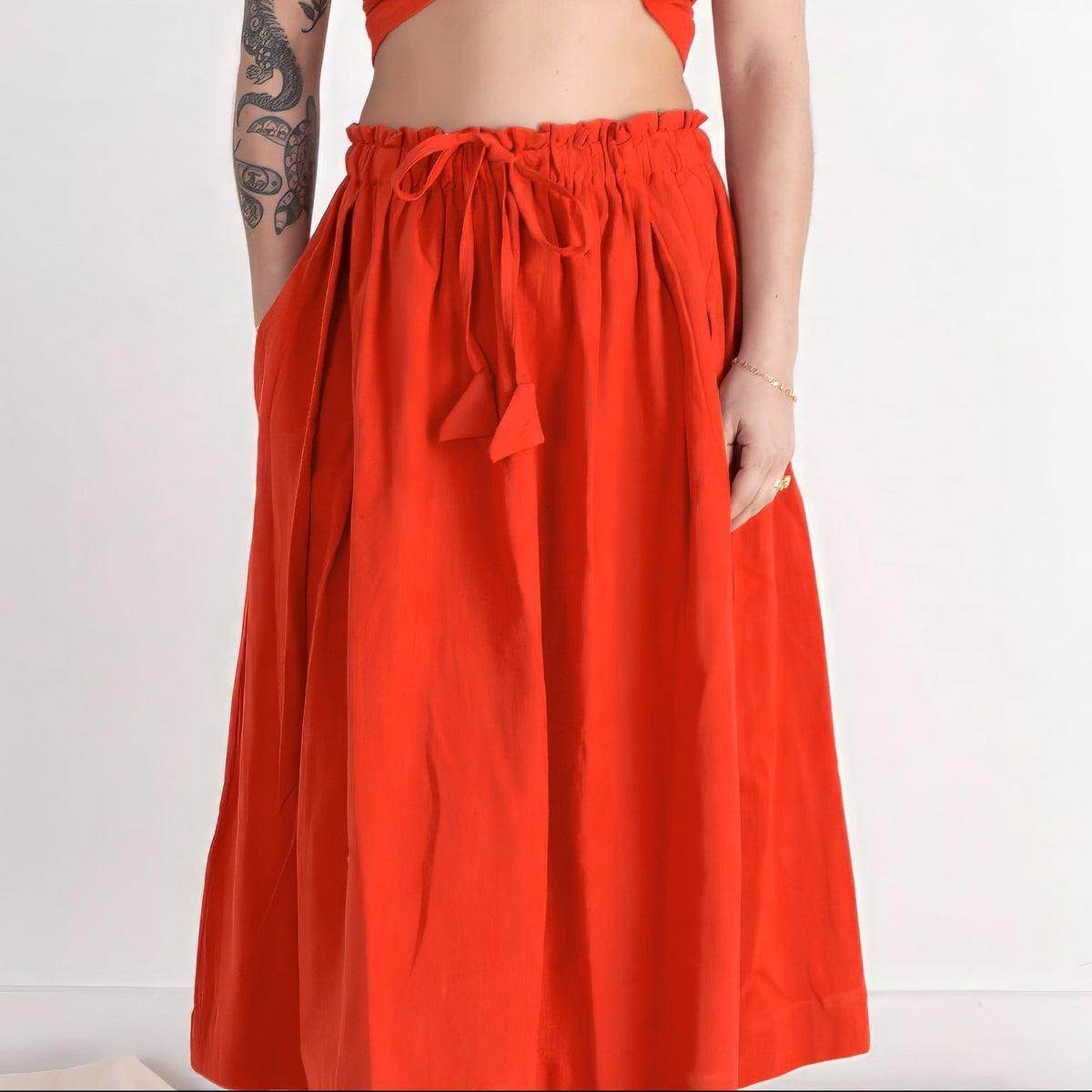 Woman wearing a red outfit on a white background