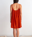 Woman wearing a red dress against a white background