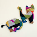 Two colorful patchwork elephant-shaped stuffed toys.